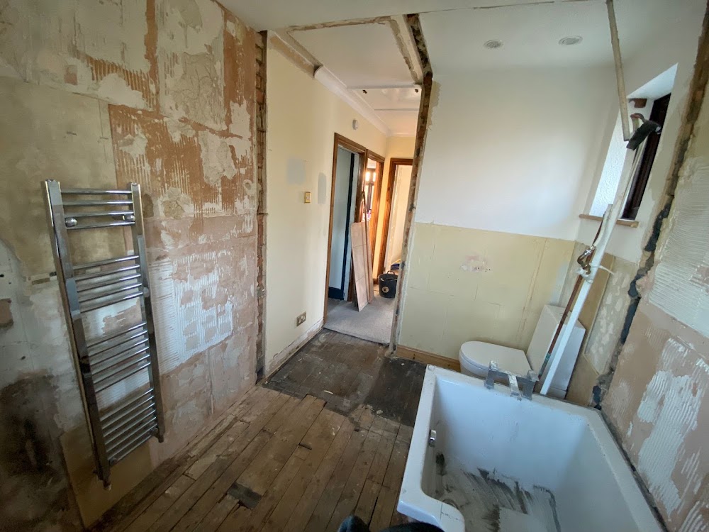 Bathroom stripped back to bare walls before the refit