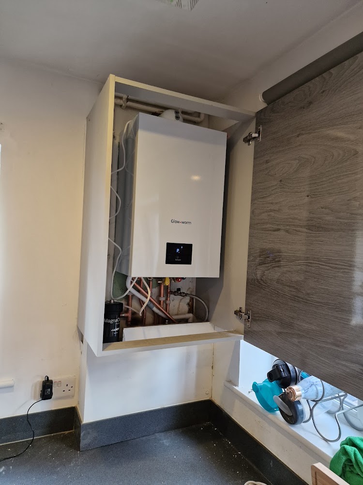 New wall-hung combi boiler installed in a kitchen cupboard