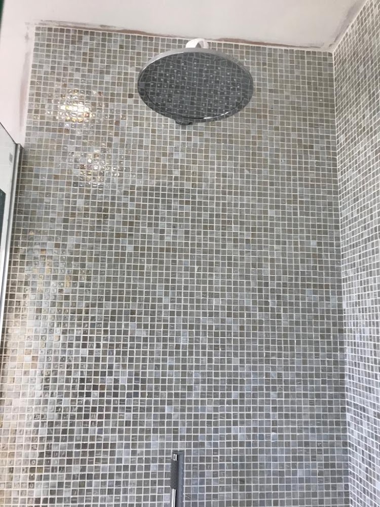 Mosaic tiled shower with ceiling rain head